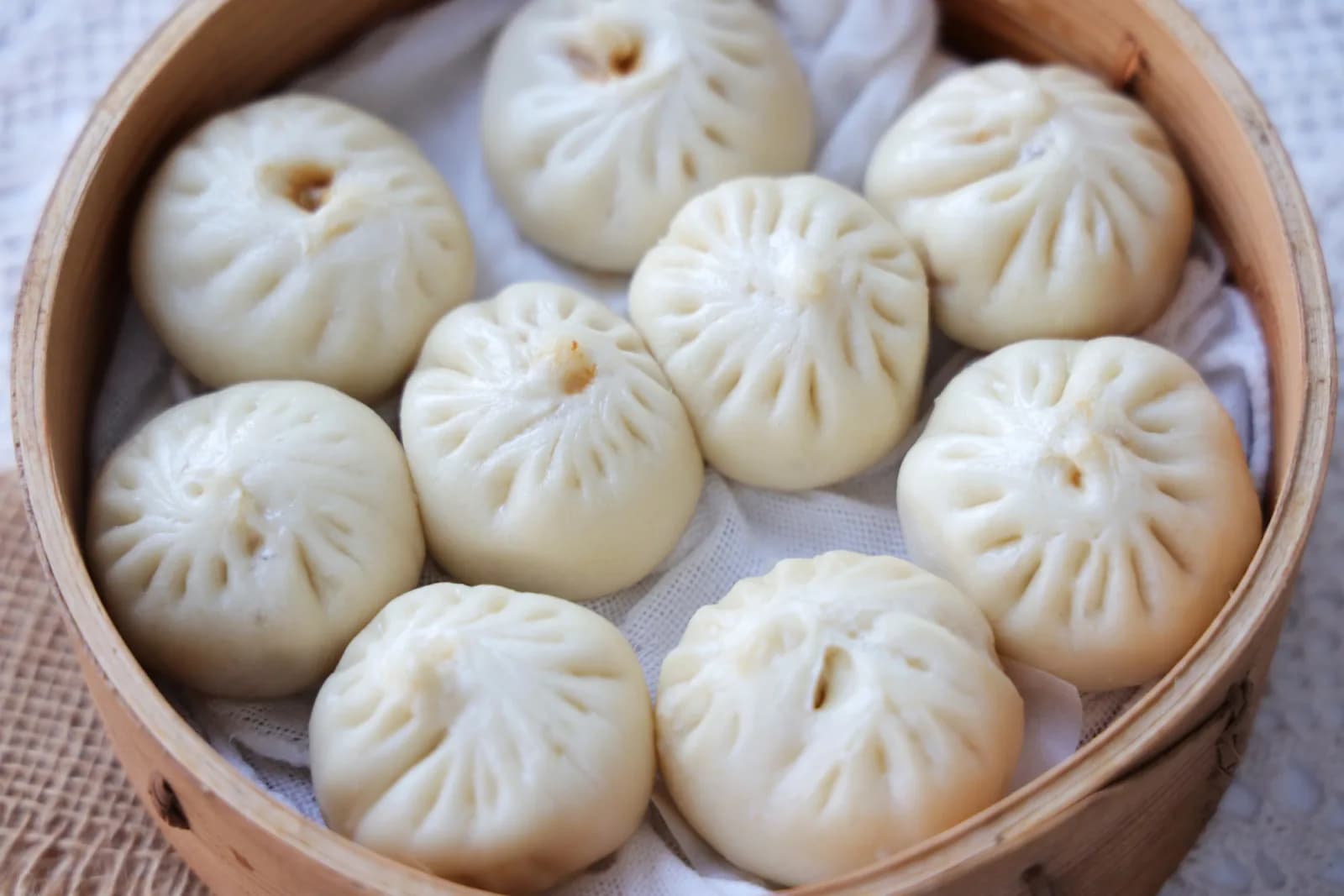 Basket of steamed xiaolongbao soup dumplings